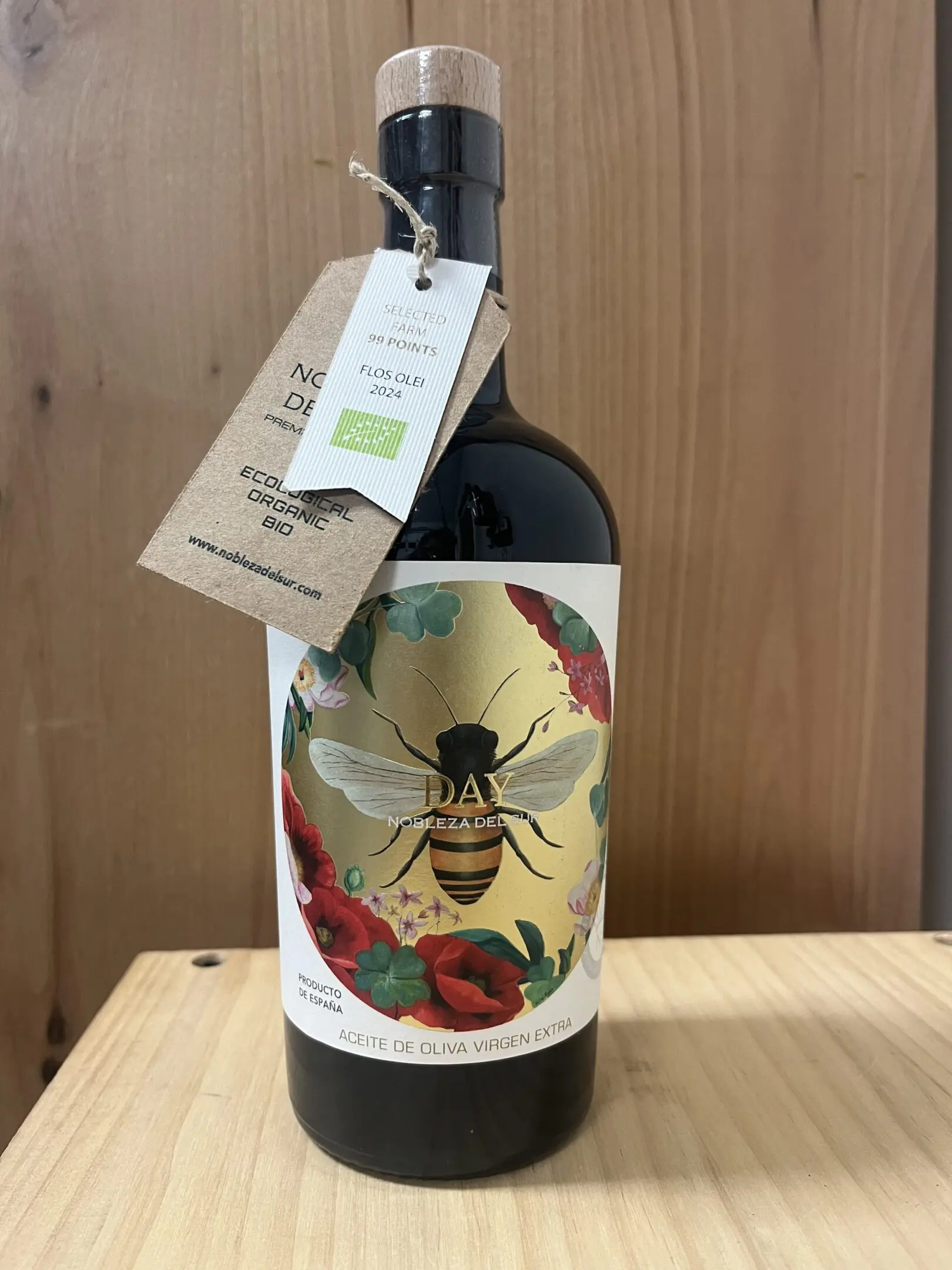 A bottle of wine with a bee and floral label design.