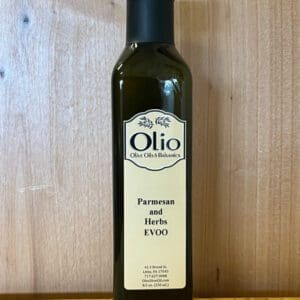 Bottle of Parma and Basil Extra Virgin Olive Oil with a wooden background.