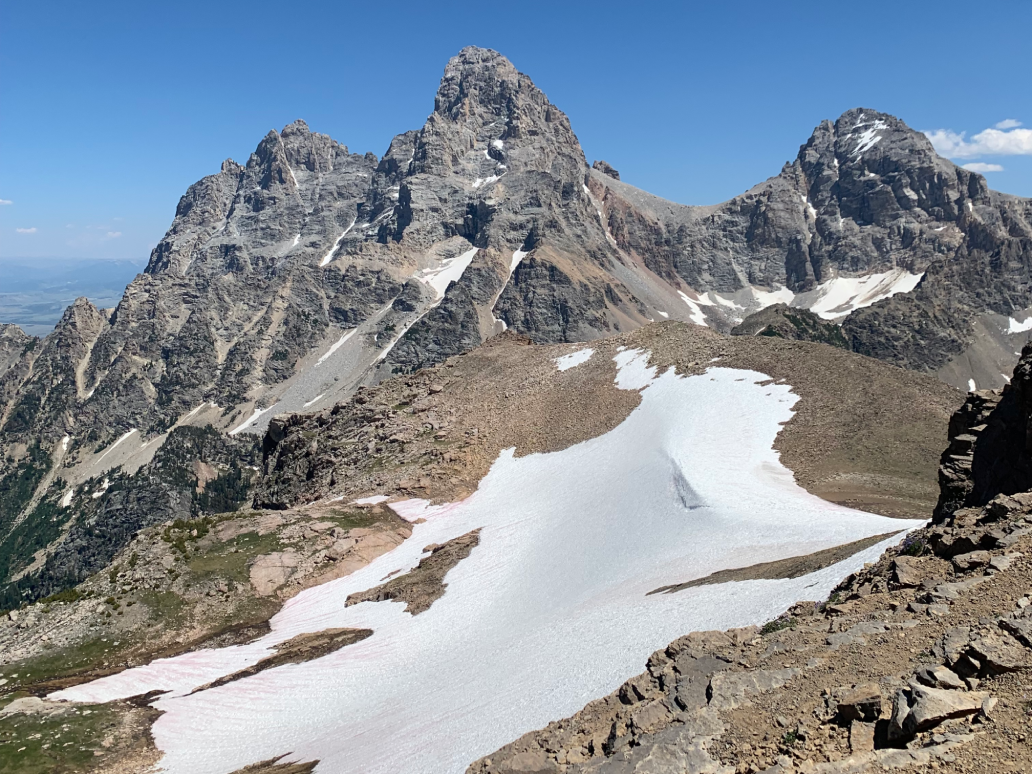 Snow-covered rocky mountain peaks under a clear sky.
