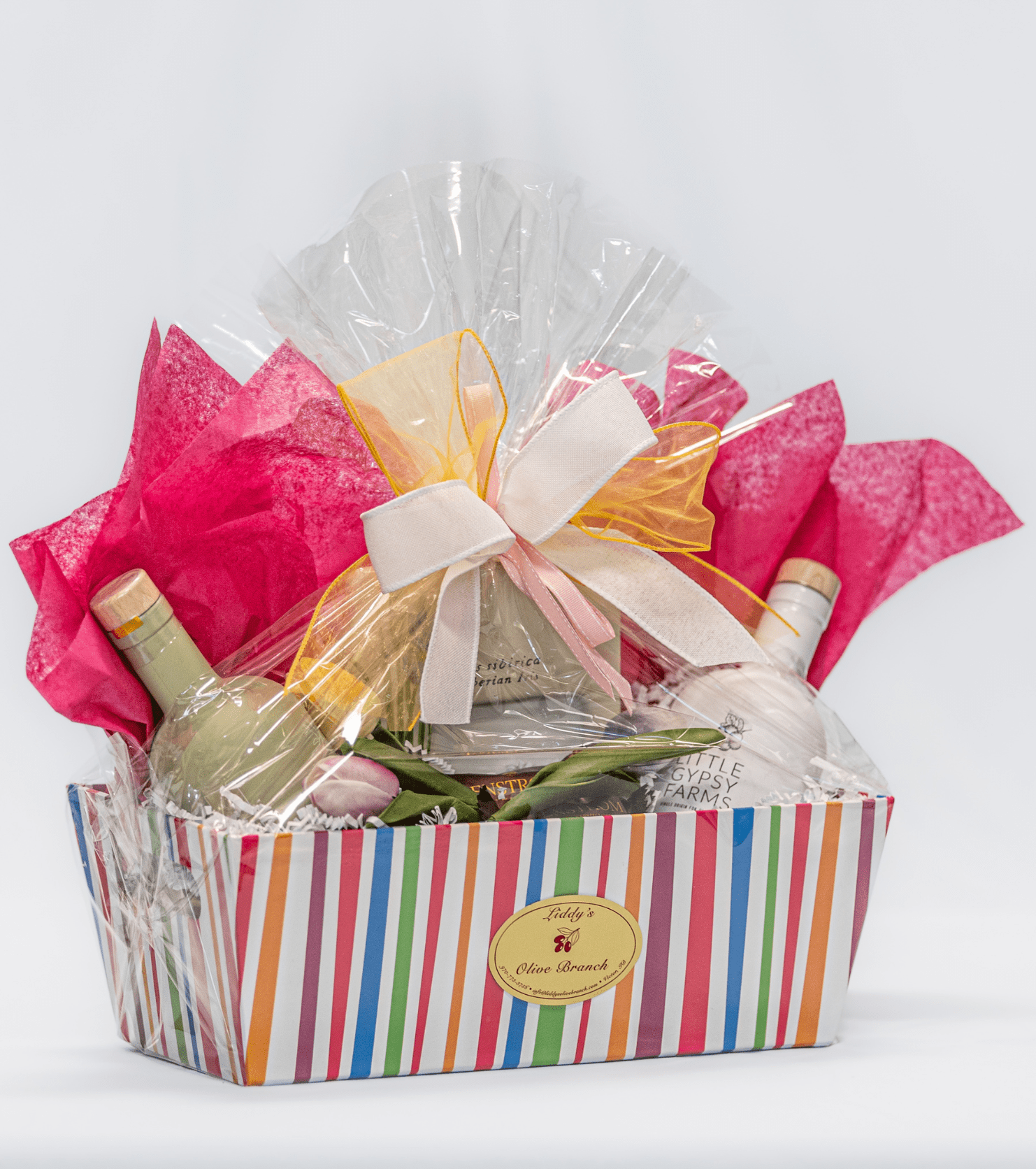 Colorful gift basket wrapped in cellophane with a large bow.